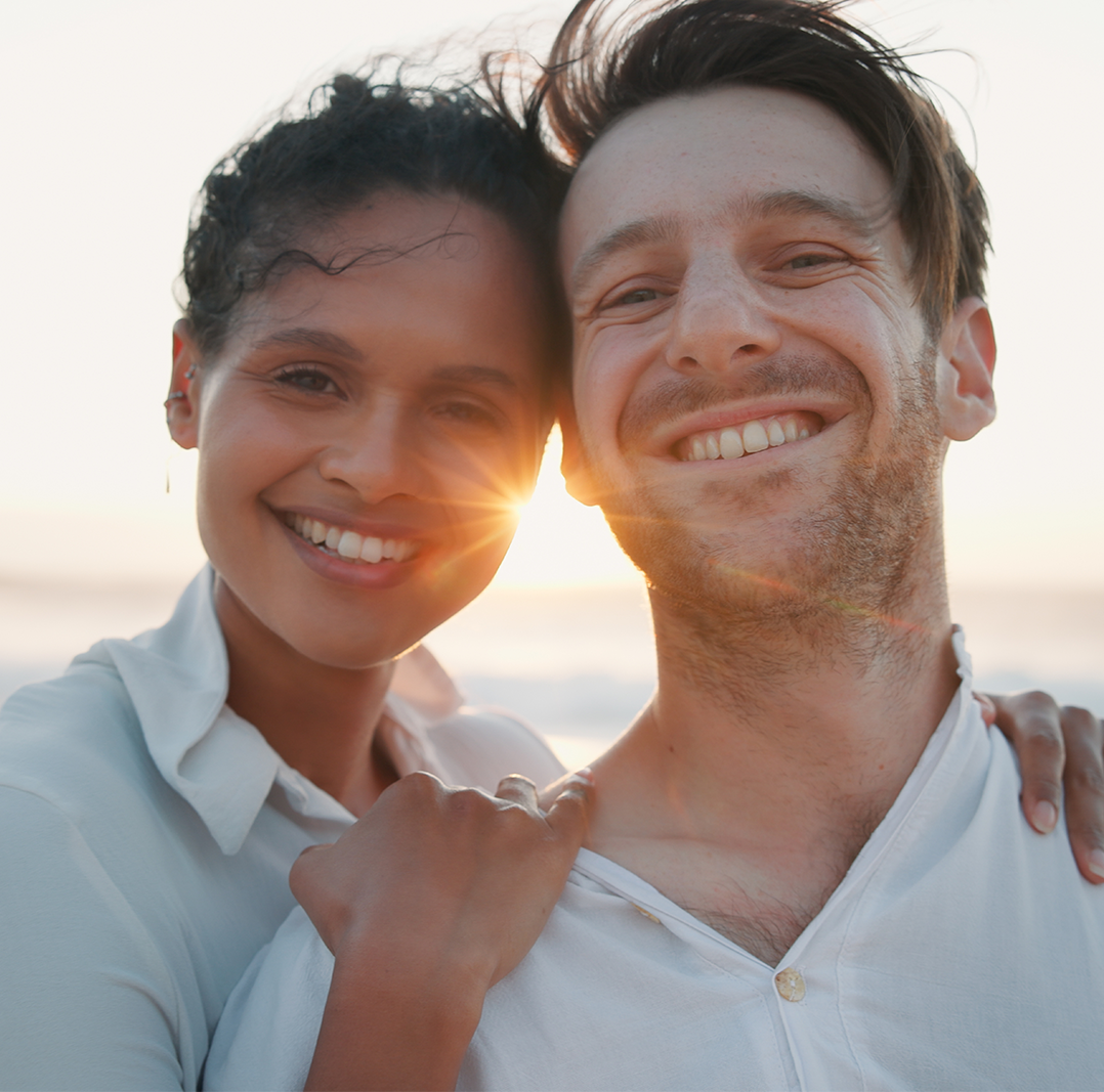 Happy Couple Smiling Outdoors After Dental Care Experience – Dentist San Diego Smiling Couple Enjoying Confident, Healthy Smiles in Natural Light – Dentist San Diego