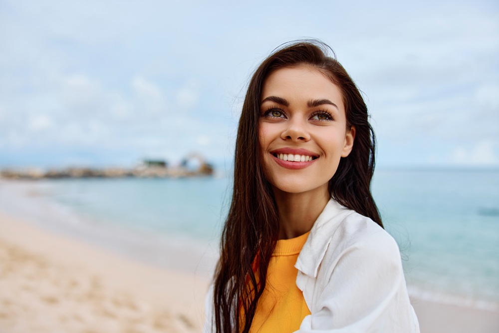 Confident Smile and Healthy Teeth by the Coast – Dentist San Diego Happy Woman Showing a Natural, Beautiful Smile Outdoors – Dentist San Diego