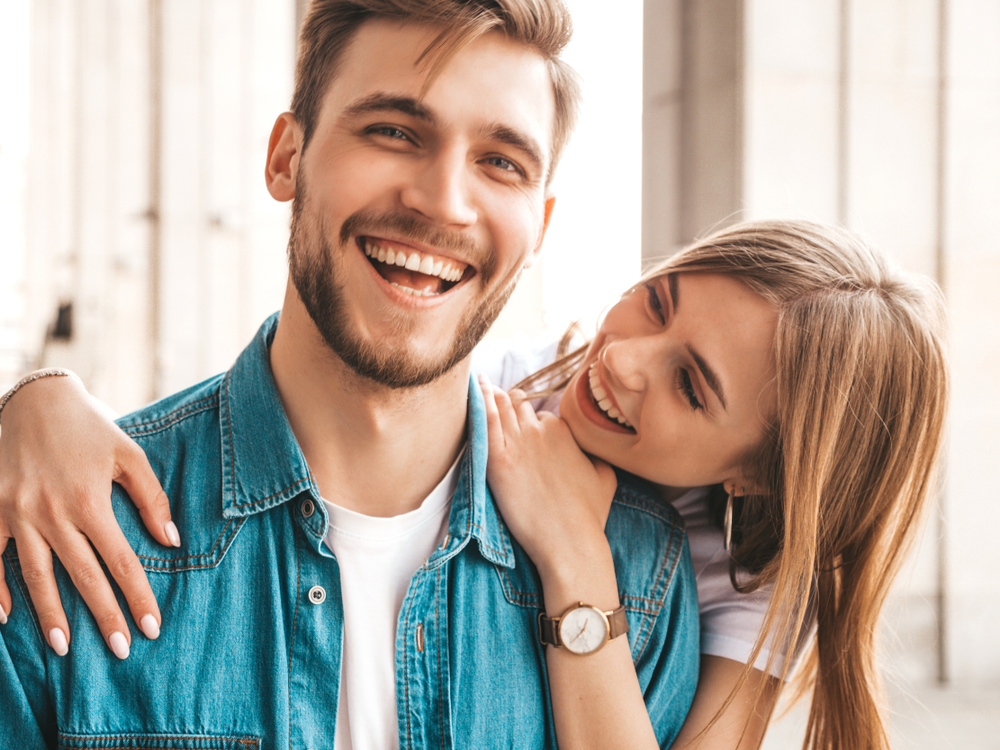 Happy Couple Smiling Outdoors After Dental Care Experience – Dentist San Diego